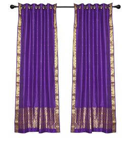 Purple sari ring top curtains hung at a window