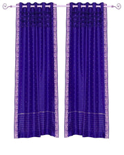 Purple sari grommet top curtains hung at a window