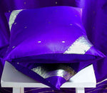 Regal purple sari cushion covers arranged on a sofa