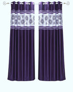 Purple sari grommet top curtains hung at a window
