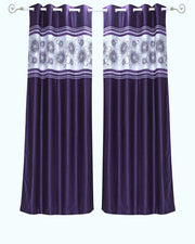Purple sari grommet top curtains hung at a window