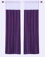 Purple velvet ring top curtains hung at a window