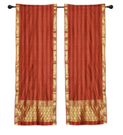 Rust sari rod pocket curtains hung at a window
