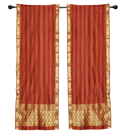 Rust sari rod pocket curtains hung at a window