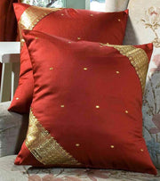 Rust sari cushion covers arranged on a sofa