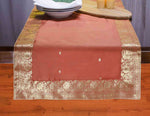 Rust silk table runner running down a dining table