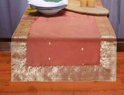 Rust silk table runner running down a dining table