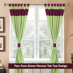 Olive green raw silk tab top curtains hung at a window