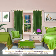 Forest green sari grommet top curtains hung at a window
