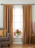 Taupe velvet tab top curtains hung at a window