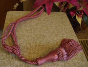 Peach sari curtain tiebacks holding a panel open