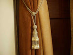 Off white sari curtain tiebacks holding a panel open