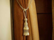 Off white sari curtain tiebacks holding a panel open