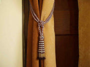 White sari curtain tiebacks holding a panel open