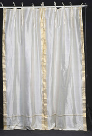 Cream sari tie top curtains hung at a window