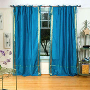 Turquoise sari tie top curtains hung at a window