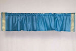 Turquoise sari valance mounted above a window