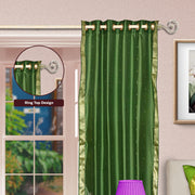 Forest green sari grommet top curtains hung at a window