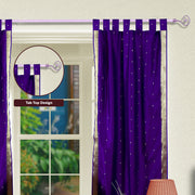 Purple sari tab top curtains hung at a window