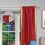 Fire brick sari rod pocket curtains hung at a window