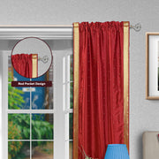 Fire brick sari rod pocket curtains hung at a window