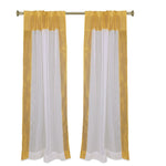 White sheer tissue rod pocket curtains hung at a window