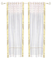 White sari grommet top curtains hung at a window