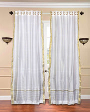 White sari grommet top curtains hung at a window