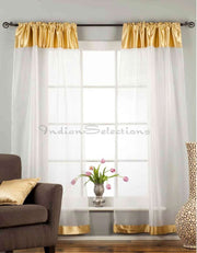White sheer tissue rod pocket curtains hung at a window
