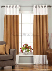Taupe velvet ring top curtains hung at a window