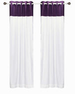 Purple velvet ring top curtains hung at a window
