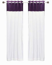 Purple velvet ring top curtains hung at a window