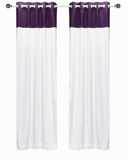 Purple velvet ring top curtains hung at a window