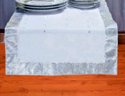 Silver silk table runner running down a dining table