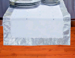 Silver silk table runner running down a dining table