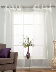 White sheer tissue tie top curtains hung at a window