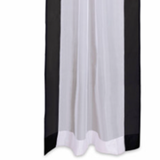 Black sheer tissue rod pocket curtains hung at a window