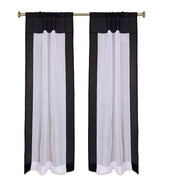Black sheer tissue rod pocket curtains hung at a window