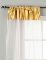 White sheer tissue rod pocket curtains hung at a window