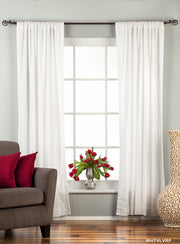 White velvet rod pocket curtains hung at a window
