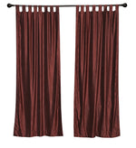 Wine velvet tab top curtains hung at a window