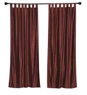 Wine velvet tab top curtains hung at a window