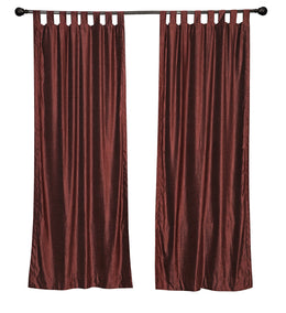 Wine velvet tab top curtains hung at a window
