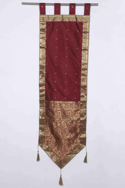 Maroon sari wall hanging displayed on a wall