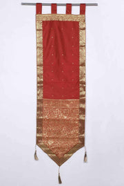 Rust sari wall hanging displayed on a wall