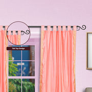 Pink sari tab top curtains hung at a window