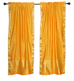 Yellow sari rod pocket curtains hung at a window