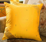 Yellow sari cushion covers arranged on a sofa