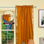 Mustard sari rod pocket curtains hung at a window